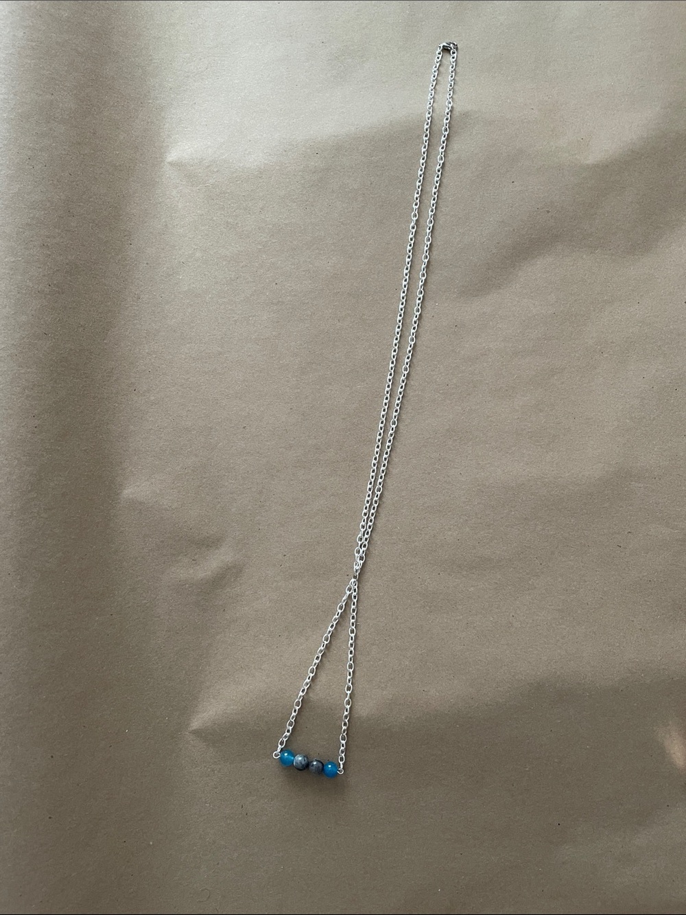 V Shaped chain necklace with gemstones.